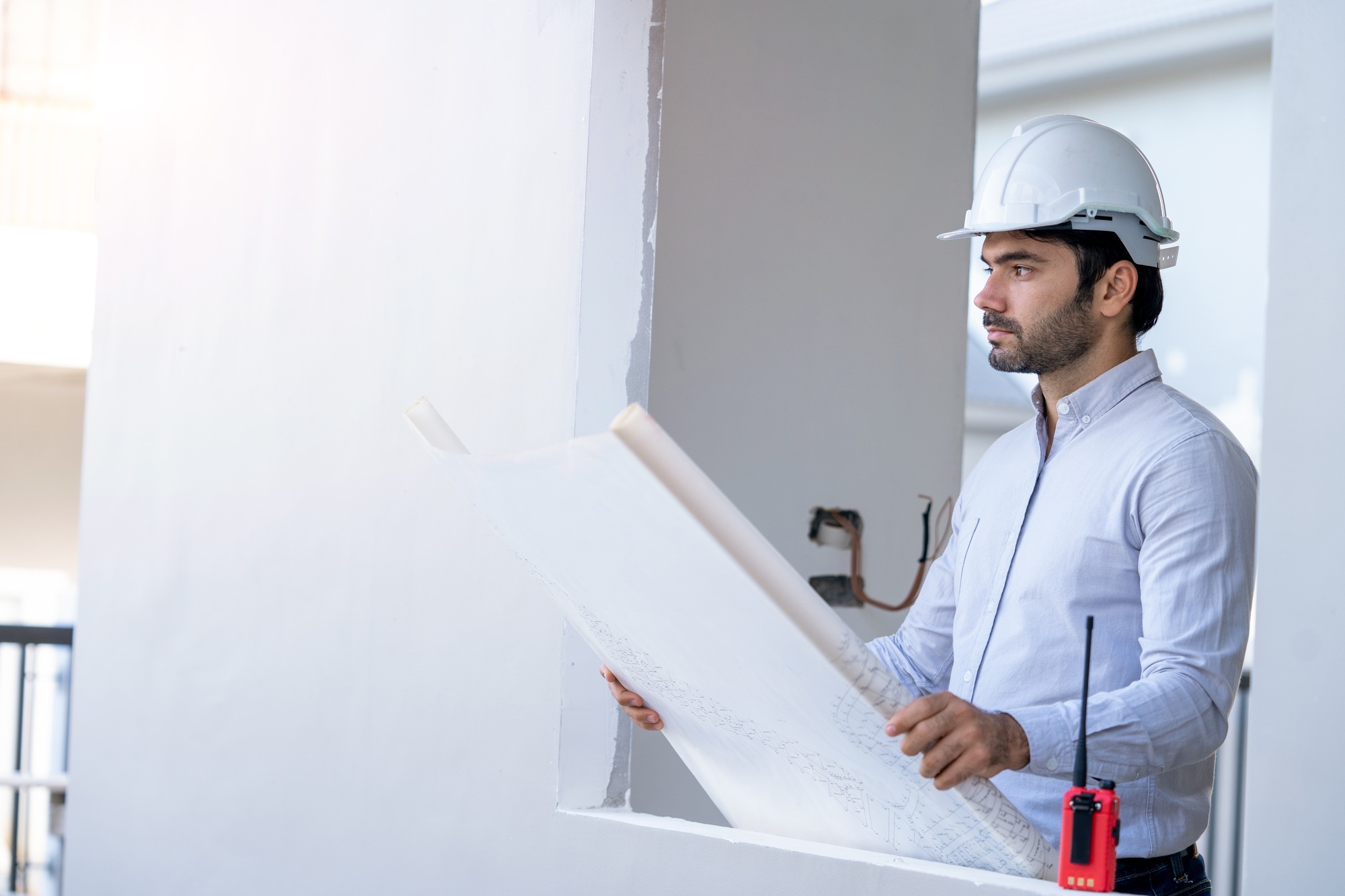 Civil engineer working with documents on construction site.