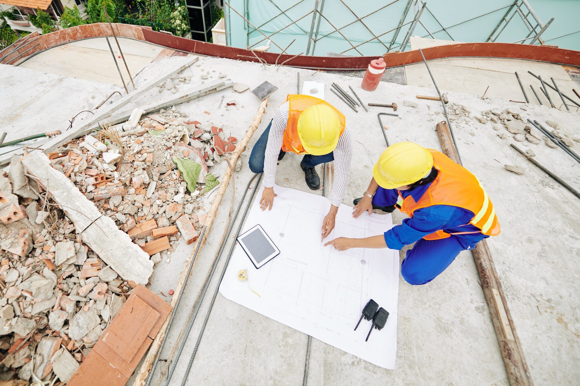 Civil engineers pointing at building plan