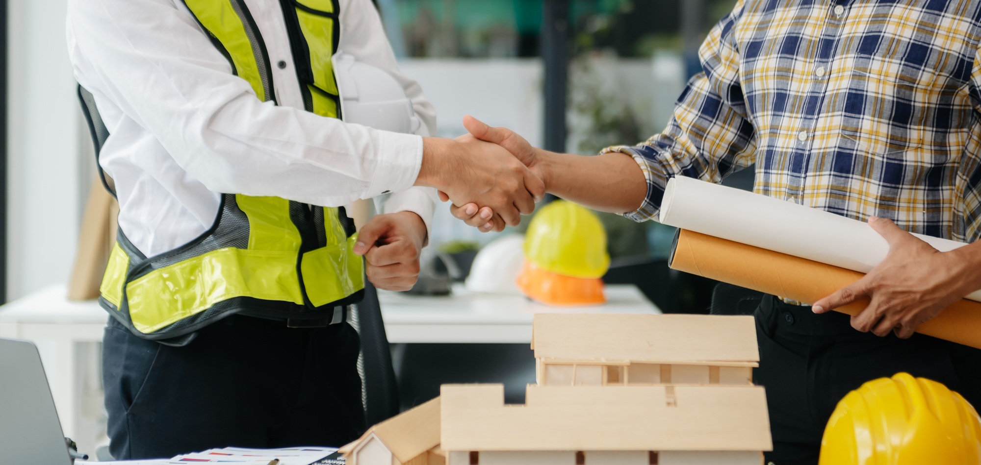 Engineer desk with object paper and tablet with blurry engineer teamwork hardworking to consults